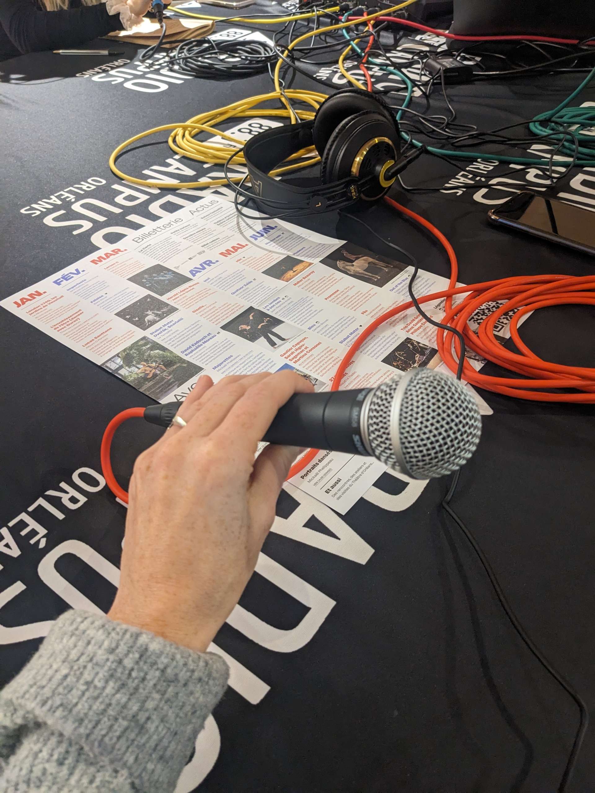 Plateau Radio Campus Orléans, photo du micro dans la main de Emeline Guémené, chargée de l'information du Théâtre d'Orléans. 