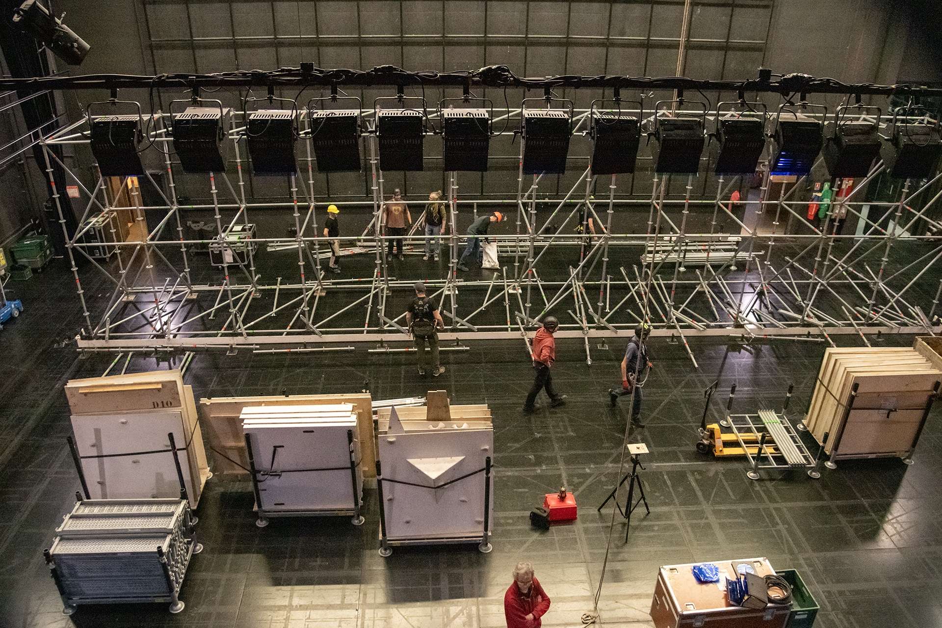 Montage d'un échafaudage et d'un mur d'escalade, vu du dessus. Plusieurs personnes sont sur le plateau.